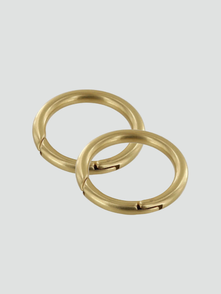 Two gold rings on a gray background #color_brass
