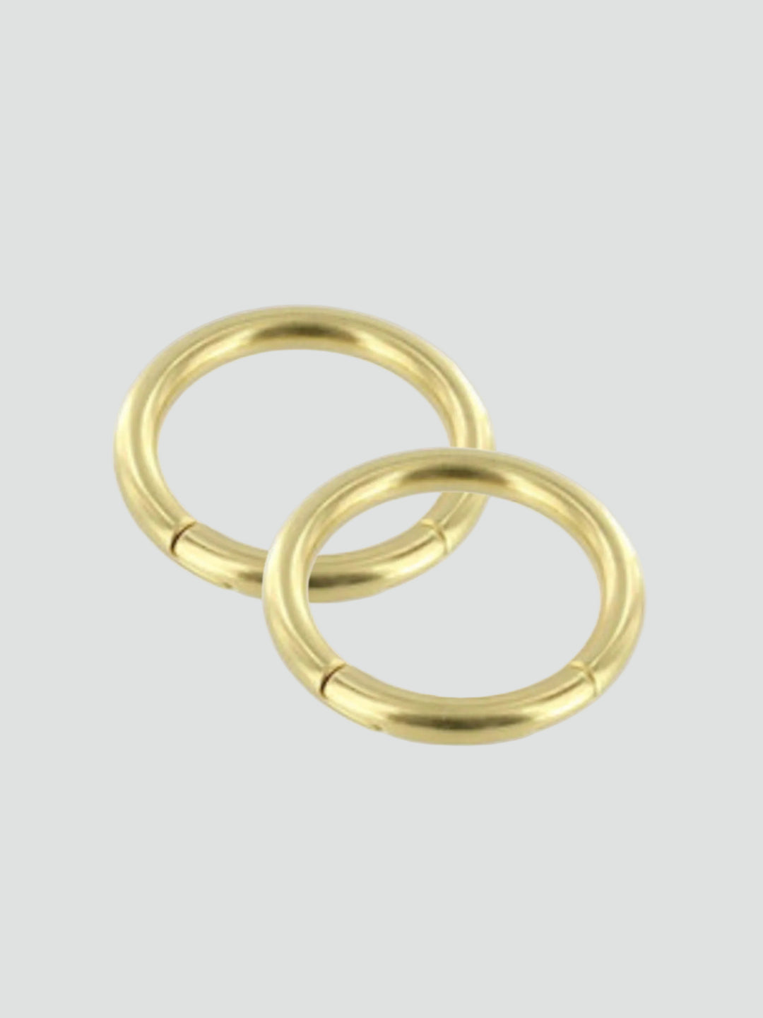 Two gold rings on a gray background #color_gold