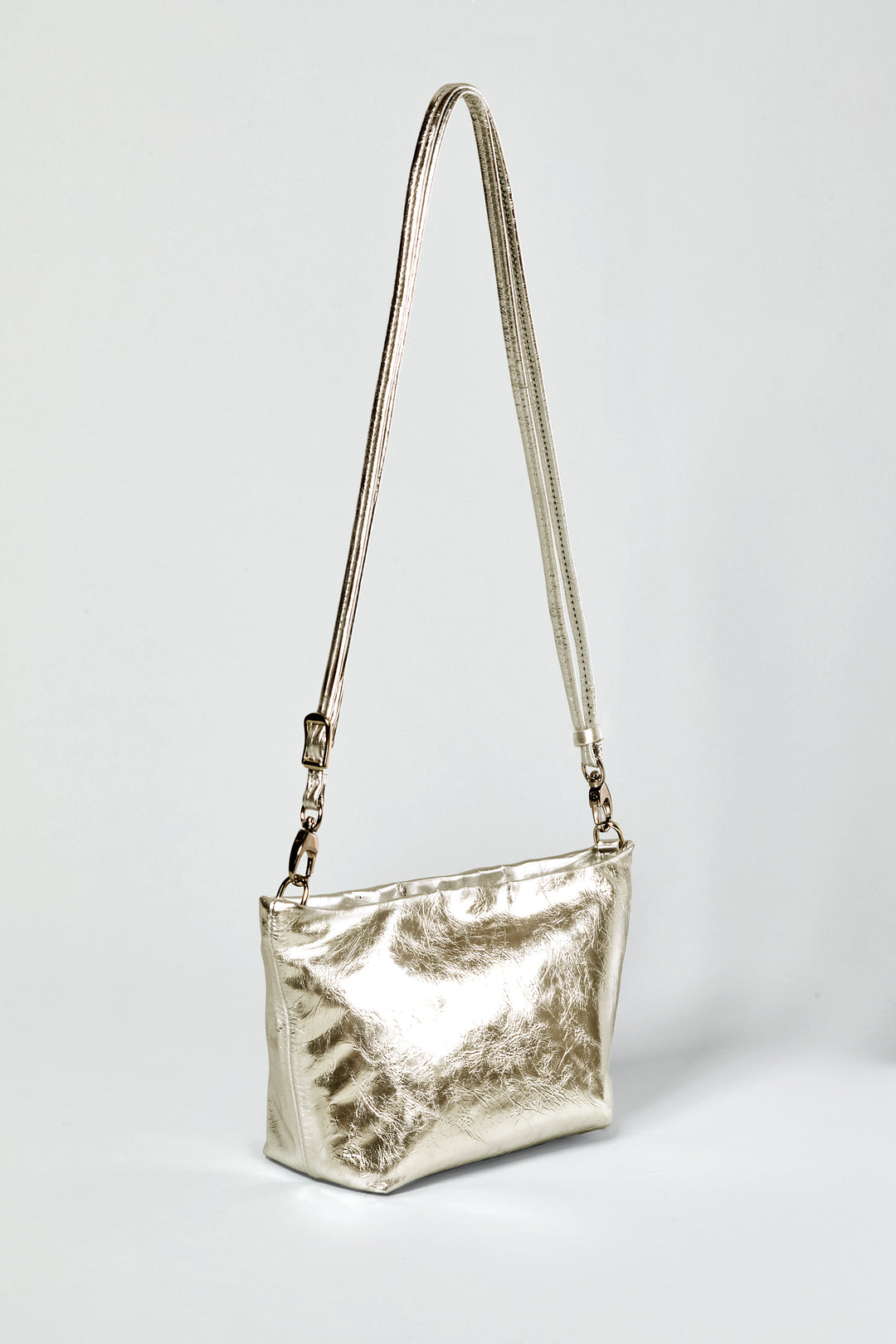 a side view of a gold leather shoulder bag with removable, adjustable long strap #color_gold