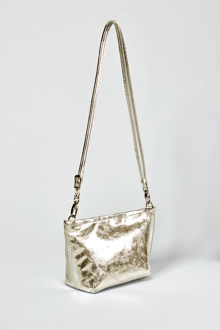 a side view of a gold leather shoulder bag with removable, adjustable long strap #color_gold