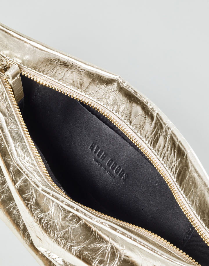 inside view of a black leather patch pocket with HYER GOODS logo embossing inside a gold leather bag #color_gold