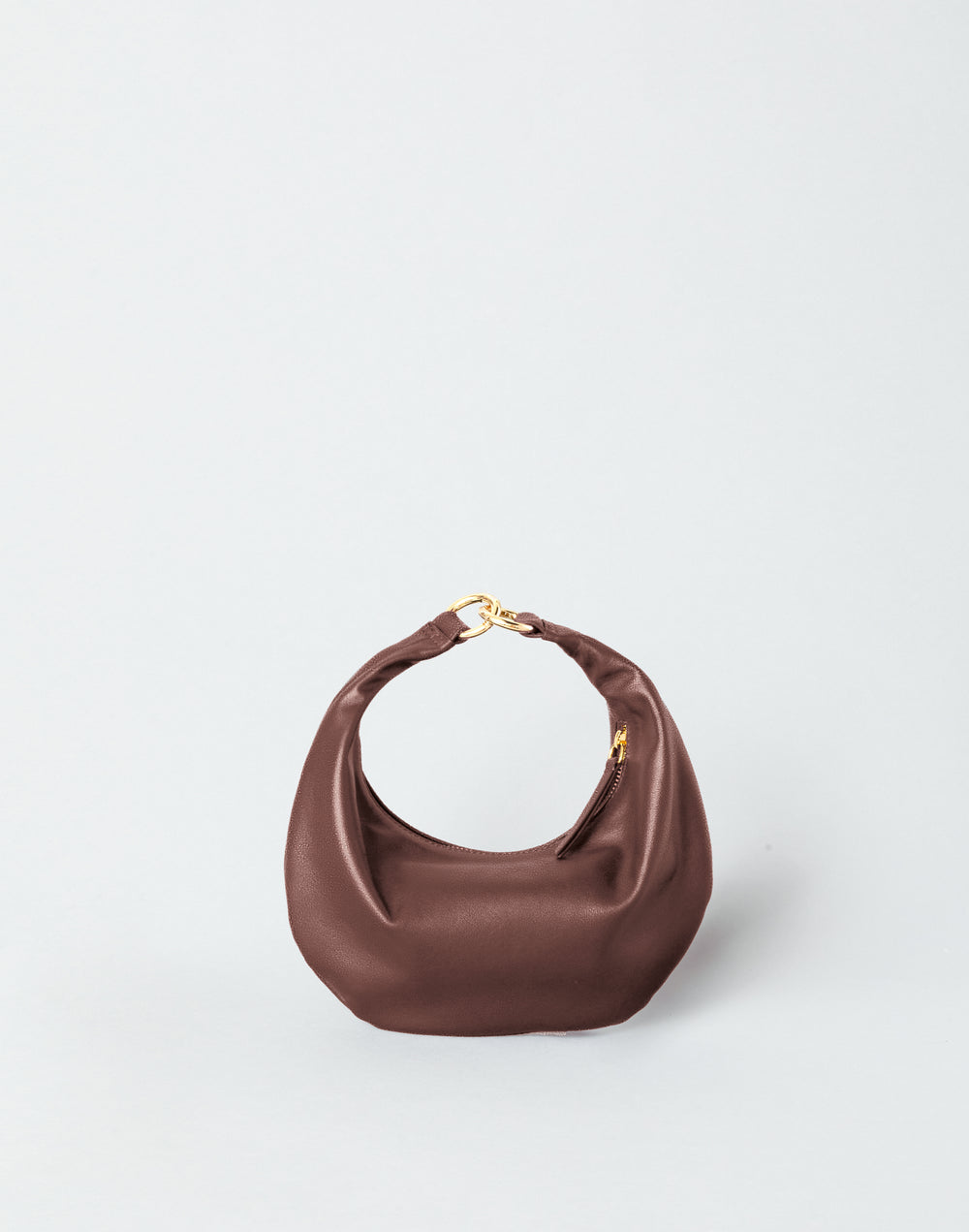 A reddish brown suede HYER GOODS micro ring bag crescent-shaped mini shoulder bag with a gold-tone metal clasp, set against a plain light gray background. #color_bordeaux-vintage