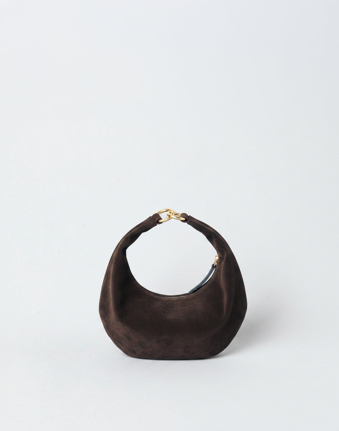 A dark brown suede HYER GOODS micro ring bag crescent-shaped mini shoulder bag with a gold-tone metal clasp, set against a plain light gray background. #color_chocolate-suede