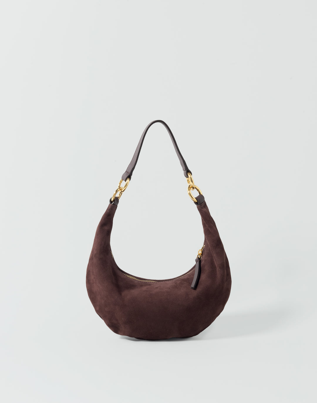 a dark brown suede crescent-shaped shoulder bag with gold-tones hardware against a grey background #color_chocolate-suede