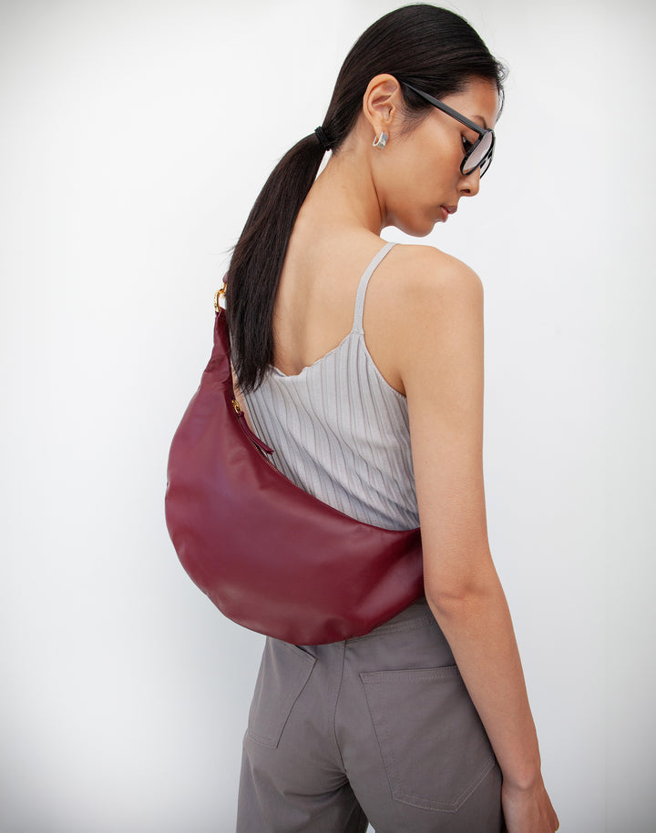 HYER GOODS convertible crossbody hobo Piccola ring bag as a crossbody #color_dark-cherry-red