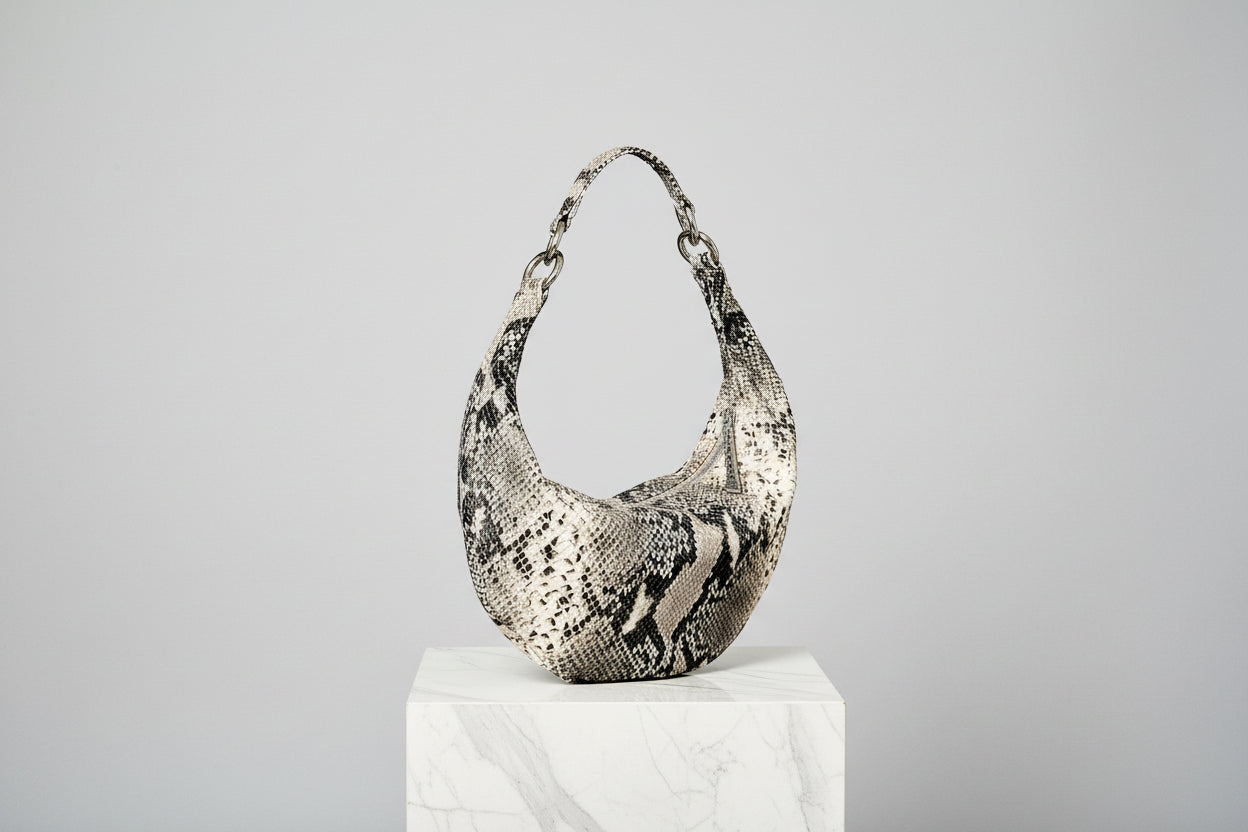 Snakeskin pattern handbag on a light gray background