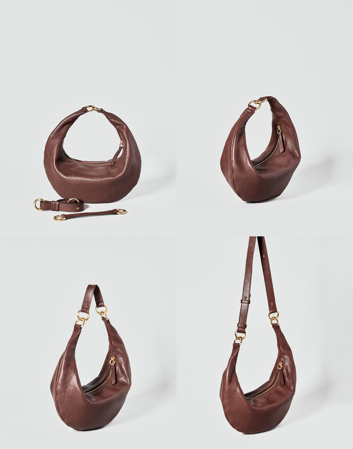 A bordeaux leather crescent-shaped shoulder bag shown from four angles on a light gray background, with one view including a detachable strap laid beside the bag. The bag has gold-tone hardware and a zip-top closure. #color_bordeaux-vintage