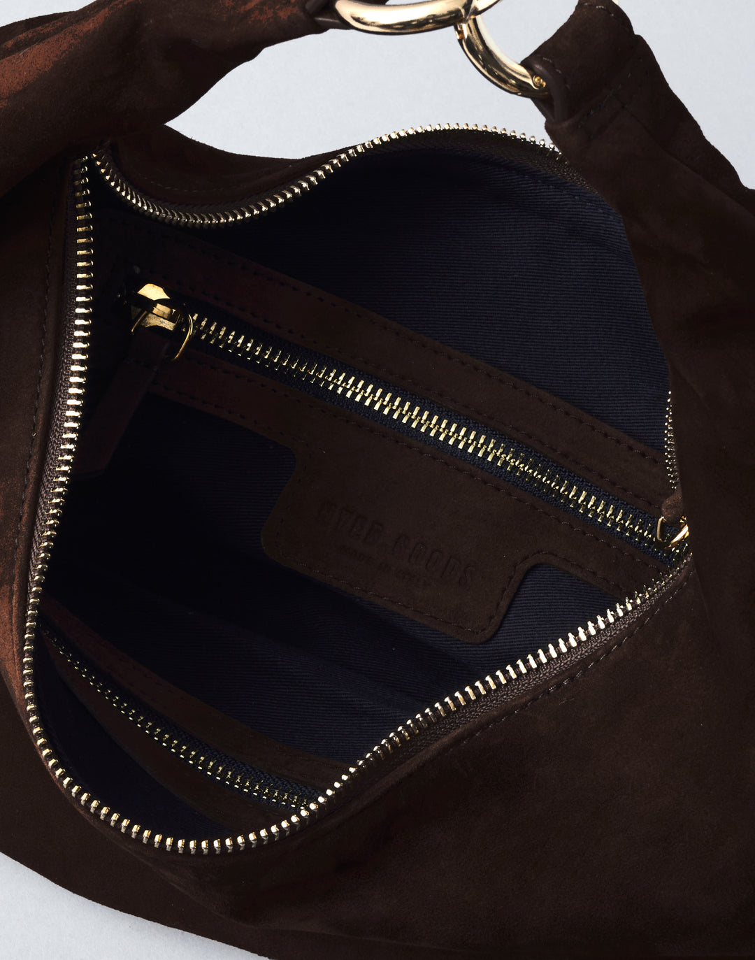 inside view of a chocolate brown suede bag with gold zipper #color_chocolate-suede