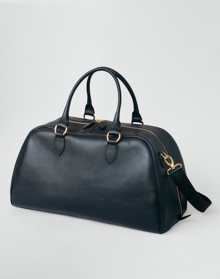 HYER GOODS black leather la via weekender duffel bag with long strap 3/4 view #color_black-gold