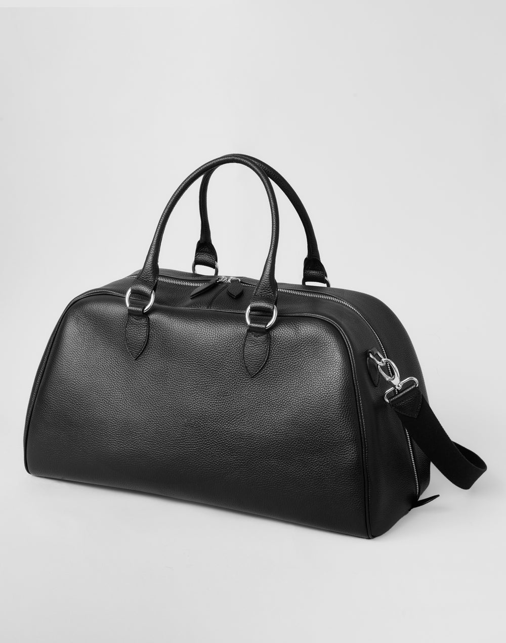 HYER GOODS black leather la via weekender duffel bag 3/4 view with long strap #color_black-silver