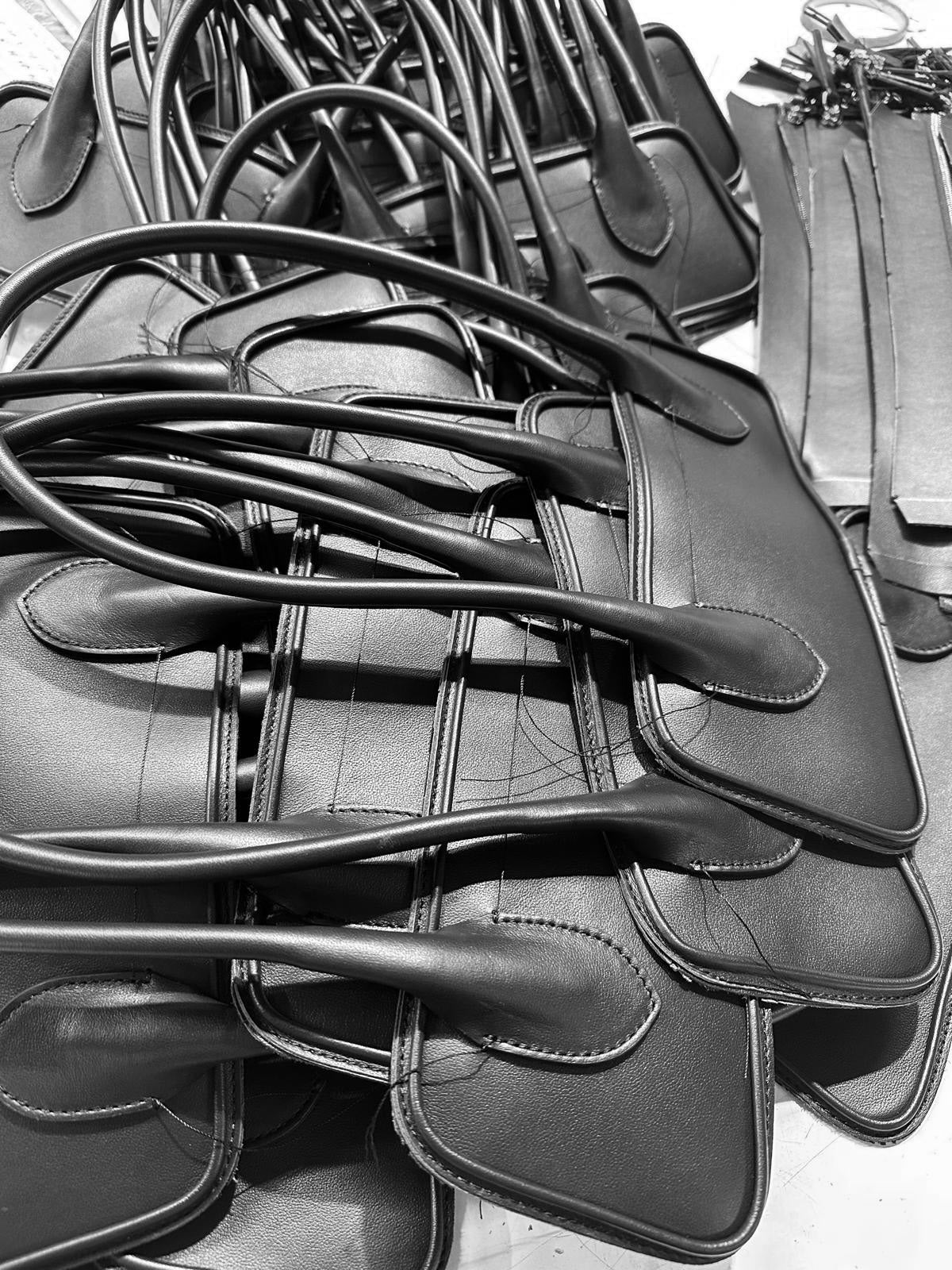 pieces of italian leather handbags during the manufacturing process